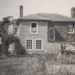 "Campo", in Hallgarth, Marshchapel. This photograph is thought to have been taken in the 1950s.
During WW2 it was used as an RAF hospital. The hospital staff lived in the house and the recuperating servicemen lived in a hut in the garden.
In the bay window of the house was a raised dais. This area was used for operations as the bay window gave the most light into the room.
