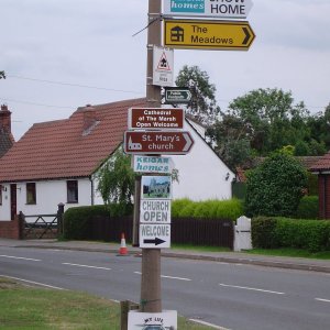 This was christened "The Totem Pole", as everyone in the village who had a sign, pinned it on this lamp post.
