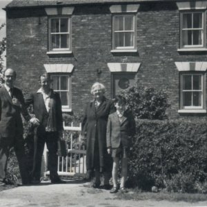 The property in this photograph is down Firebeacon Lane (coming from main road 1031, it is the first on the right).
The property was owned by Jack Burgess, a Marshchapel farmer and Len and Mirrie Leak left Fieldsend Terrace to move into this property.
Left to right: Harry Oxley, Len Leak, Florrie Leak, Kevin Taylor (Florries grandson).