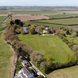Aerial view looking West with the Wolds in the background.
Duckthorpe Lane runs across the photo.