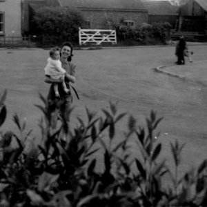 In the foreground is Kath Grantham with her son Stuart.
In the background can be seen the house the Granthams lived in next to the offices and joinery workhop of Mr. Rigall on Sea Dyke Way opposite the War Memorial.
This photograoh was taken 1944/5