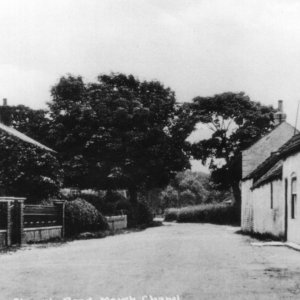 View down Church Lane.
The cottage on the far right, just before the trees was called "Anglia".
Mrs M. Atkinson "known as Mother Ack," lived there.
