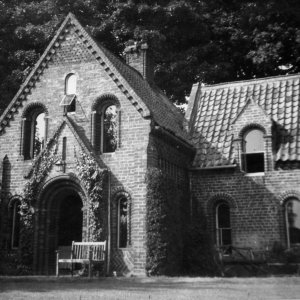 This photograph of Norman Cottage was taken after WW2.
When compared to a pre-WW2 photograph, it can be seen that some of the sash windows have been removed and replaced with plain glass.
