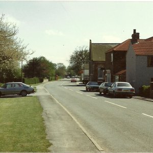 Bonners Cottage can be seen on the right, just before the corner shop which was open at that time.
This photograph was taken before the layby was built in front of Fieldsend Terrace.
This was to give motorists a parking space whilst visiting the shop.