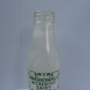 This milk bottle was donated recently (2021) by Stephen Wray. 
 We dont have any exact dates when this business was in operation but have been told that Joyce Berry, who lived in Marshchapel, used to deliver milk for Cliff Wray in the 1940s - on her bike.