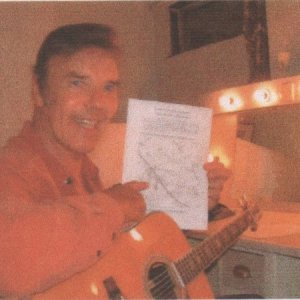 Marty Wilde pointing to map of Marshchapel where he made an 

appearance to support fund raising for the  Marshchapel First Responders in 2003.