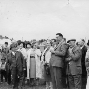 Possibly a Garden Fete at the Village Hall.
John Smith "middle right", sharing a joke with whom. Mr Hewson "with the cap", is on the right of John Smith.