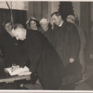 Bishop of Lincoln, Kenneth Richies visit to St. Marys Church, Marshchapel.
Signing book, Kenneth Richies, Bishop of Lincoln, standing behind him Rev. Joseph Sykes, Vicar of Marshchapel, 
Left to right: Sarah J Patrick, Margaret Burgess, Maria (known as "Mother Ak") Atkinson, Mr Wylie, Fred Kirk.