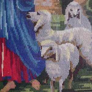 Section of the needlework picture near the stained glass window.