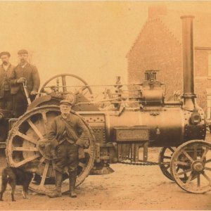 We have no information as to where this photograph was taken or who the men are in it
Steam engines of this type would travel from farm to farm.
One of their uses was to operate the threshing mahines after harvest.