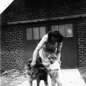 Barbara Whiteley with her son Ray and dog Jerry.
This photograph was taken at the back of the Butchers Shop on Sea Dyke Way, Marshchapel.
The building in the background is the old slaughterhouse.