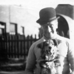 Frank Whiteley, the owner of the butchers shop on Sea Dyke Way, Marshchapel, with his dog Judy.
This photograph is taken in the back garden of the butchers shop.
The back of the neighbouring house with fish shop an be seen in the background.