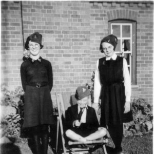 Joyce Cross, Colin Lyons, Jean Lyons and "Dinky" the dog.
Photograph taken in the School House garden September 1940.