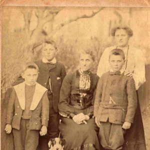 Centre seated is Mary Ann Atkin - nee Silvester - 1859 to 1920.
The lady standing at the back is her daughter, Edith and the young boys are Ediths brothers, one of the boys is called Sid.