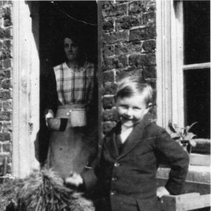 Raymond Parker with his dog.
His mother can be seen in the doorway.