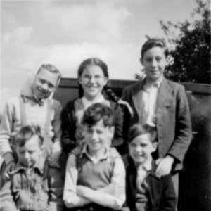 This photograph was taken in front of the old Village Hall near the house where the Granthams lived - now demolished.
Circa 1950.
Left to right; Back row: Janet Richardson, Irene Maddison, John Campbell.
Front row: Stuart Grantham, Tony Burgess, David Scrimshaw.