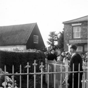 Frred Grantham laying a wreath at the War Memorial on behalf of the "Buffaloes"
C. 1950s
In the background can be seen the roof of one of the old cottages which ran across the entrance to what is now Harpham Road.