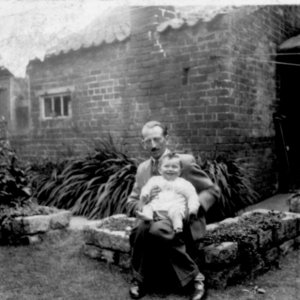 Fred Grantham with his son Stuart.
This photograph was taken in the back garden of the Joiners Workshop on Sea Dyke Way, in front of the Village Hall.
C. 1944 or 1945