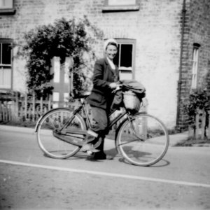 Kath Grantham outside their cottage which used to stand in front of the Village Hall on Sea Dyke Way.  This cottage has now been demolished.