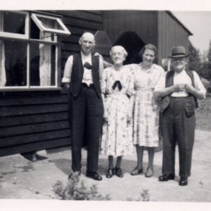 Left to right: Harry Sargent, Mrs Farmery, Nora Sargent and Mr Farmery. 
Mr and Mrs Farmery lived in the neighbouring wooden bungalow in Littlefield Lane.