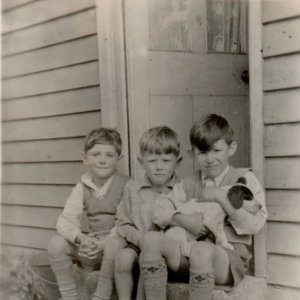 Trevor Clover, Chris Leak and Richard Marshall.
This photograph would have been taken in the early 1950s.
From the building in the background this could have been the wooden bungalow which stood in Littlefield Lane on the right hand side before the turning into Hallgarth.