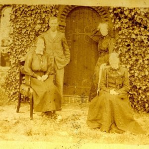 This photograph was taken outside Norman Cottage which is to the rear of St. Marys Church.
Unfortunately the people in the photograph are unknown.