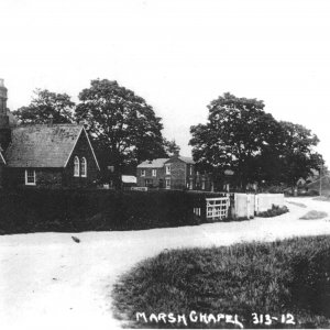 Marshchapel School. The date of this postcard is unknown.
In the background can be seen the White Horse Inn and to the right of the picture can be seen the two cottages that stood next to the road.
