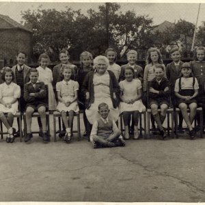 Nora Lyons - Class of 1949.
Back row: Janet Richardson, Sally Parker, Graham Hopper, Sylvia Pell, Mason Fenner, Janet Wray, Libby Orris,
Roly Leak, Vera Worrell, Desmond Hunswick, Jean Kirk, Wendy Todds.
Front row: Irene Maddison, Roy Pickard, Sylvia Nicholson, Barry Ireland, Caroline Preston, Nora Lyons - Teacher - Julie Lyons, Ivor Jacklin, Jean Wilson, Brian Riggall, Hazel Clarke.
Sitting at front: Graham Atkinson.