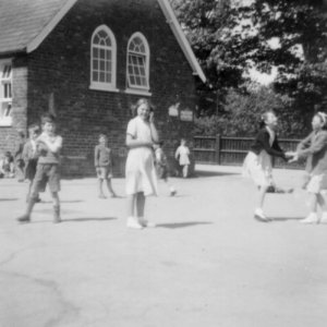 Marshchapel School Playground - The two girls holding hands with arms crossed are playing "Skitter-Scatter".