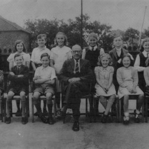 Photograph taken in Marshchapel School playground c. 1948 or 1949.
Back row: Betty Wray, Trevor Nicholson, Margaret Chapman, Valerie Riggall, Robert Evison, Jasmine Hancock.
Front row: Rex Johnson, John Brooks, John Campbell, Percy Lyons - Headmaster - Jennifer Leak, Marjorie Marshall, Nesta Leesing.