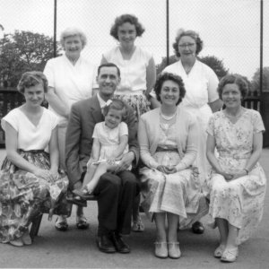 Photograph taken in Marshchapel School playground.
Back row: Mabel Manders, Assistant Cook, Rosemary Cheffins - School Secretary, Marion Lyons - Cook
Front row: Mrs Daphne Knight - nee Campion - John Cockerill - Headmaster - with his daughter Jill on his knee, Mrs Cockerill, Mrs Kathleen Williams - Teacher.