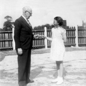 Percy Lyons, the retiring Headmaster, being presented with a watch to mark the occasion, by pupil Janet Richardson. He retired in 1952.