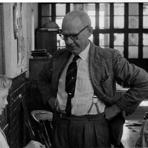 Percy Lyons, Headmaster, with Roland Leak on the left and Roy Pickard.
This photograph clearly shows the partition that divided the room into two classrooms, one for lower juniors, the upper juniors being in this classroom.  Tables were set up in this room where the school dinners were served.