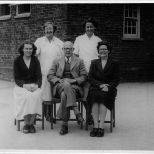 This photograph was taken in the School playground.
Back row: Marion Lyons - Percys daughter and School cook, Peggy Atkinson - Asst. Cook.
Front row: Miss Green, Percy Lyons - Headmaster - Mrs Newton - teacher.