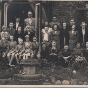 This photograph was made into a postcard.
It looks like a school outing with Percy Lyons, the Headmaster, standing in the doorway.
The legend on the reverse of the postcard reads "Taken at Hull June 1938".