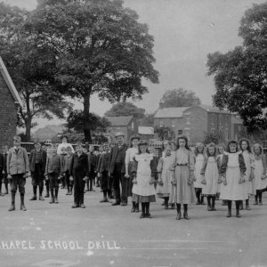Another School Drill dating from the early 1900s.
It is impossible to count the number of pupils shown here but it must have been a very well attended school.
The White Horse Inn can be seen in the background.