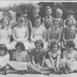 Photograph taken in school playground c. 1962.
Back row: Robert Lacey, Barry Lowis, Eric Dowlman, Nigel Lovett, Alan Wray, Martin Wray, Alan Peart, Nick Stones.
Middle row: Christine Cheese, Yvonne Manders, Sandra Welton, Alma Epton, Kathleen Bartholemew.
Front row: Lynne Jacklin, Anne Oxborrow, Diane Worrell, Marlene Horry, Bev. Ireland.